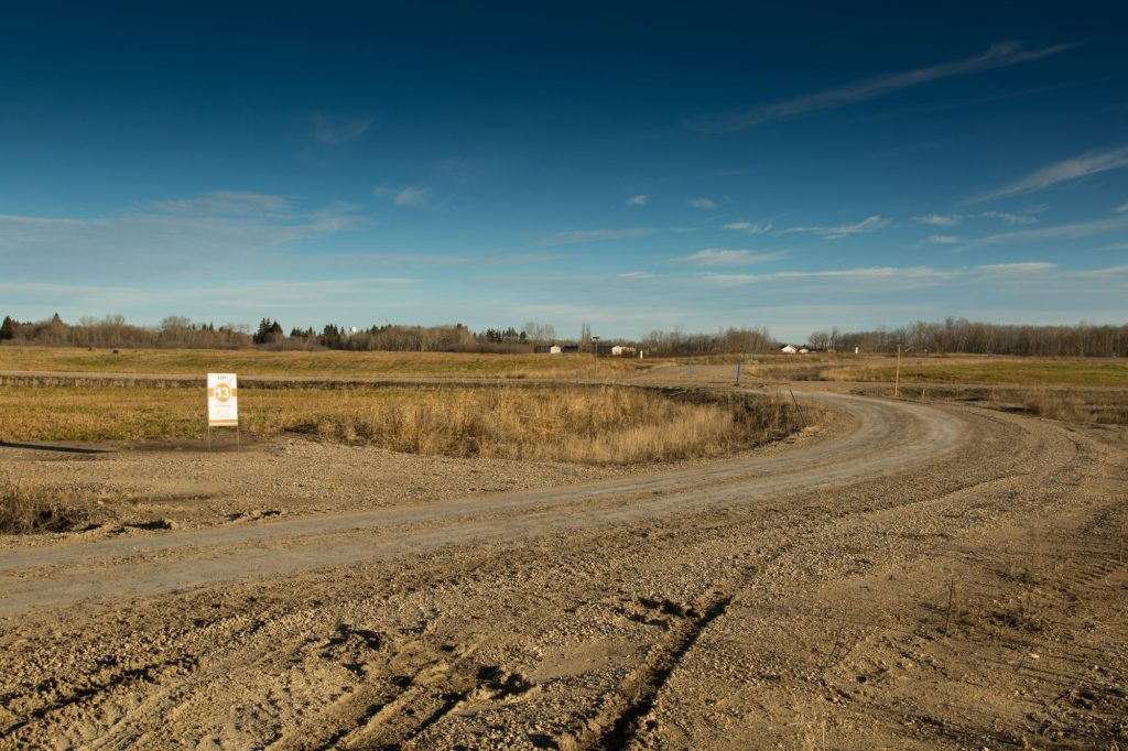Gravel road curving through freshly graded Brylee Estates lots