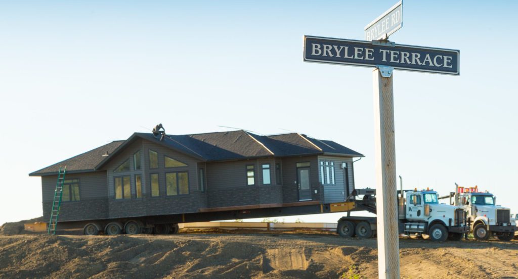 Ready-to-move home being delivered beside the Brylee Terrace sign