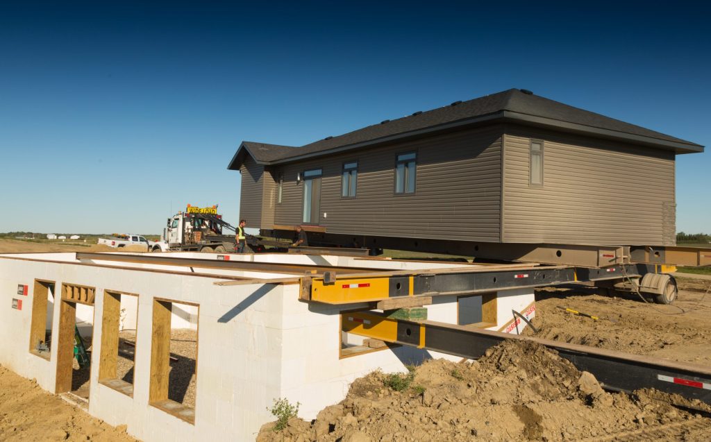Ready-to-move home being lowered onto a new foundation at Brylee Estates