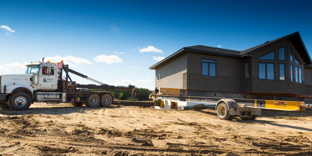Ready-to-move home being delivered by truck to a Brylee Estates lot