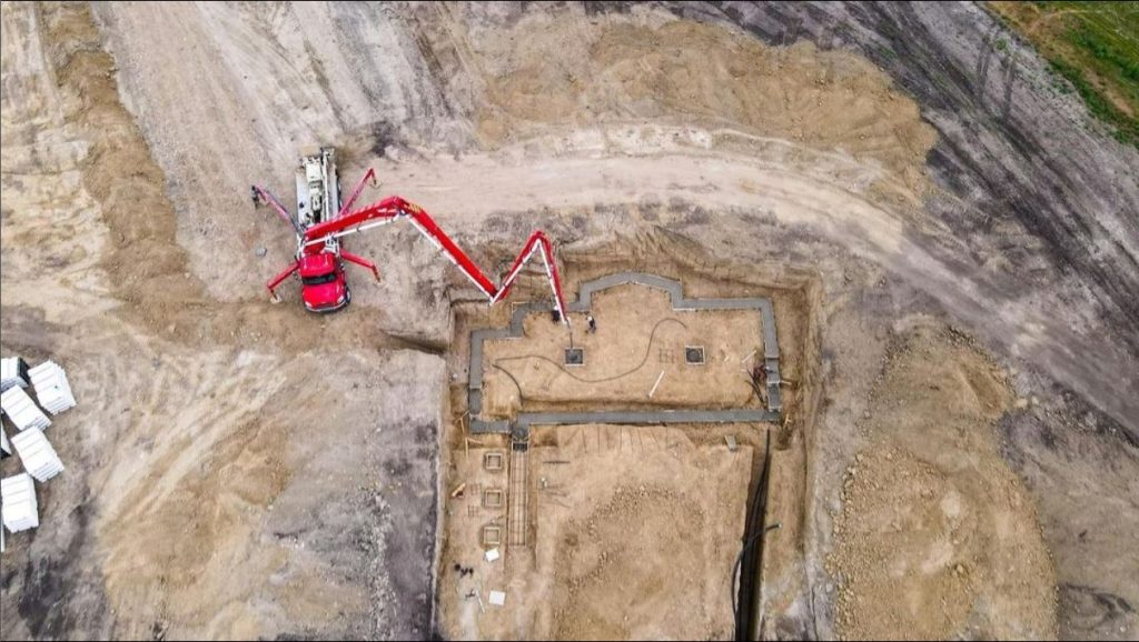 Aerial view of a concrete pump pouring a Brylee Estates foundation
