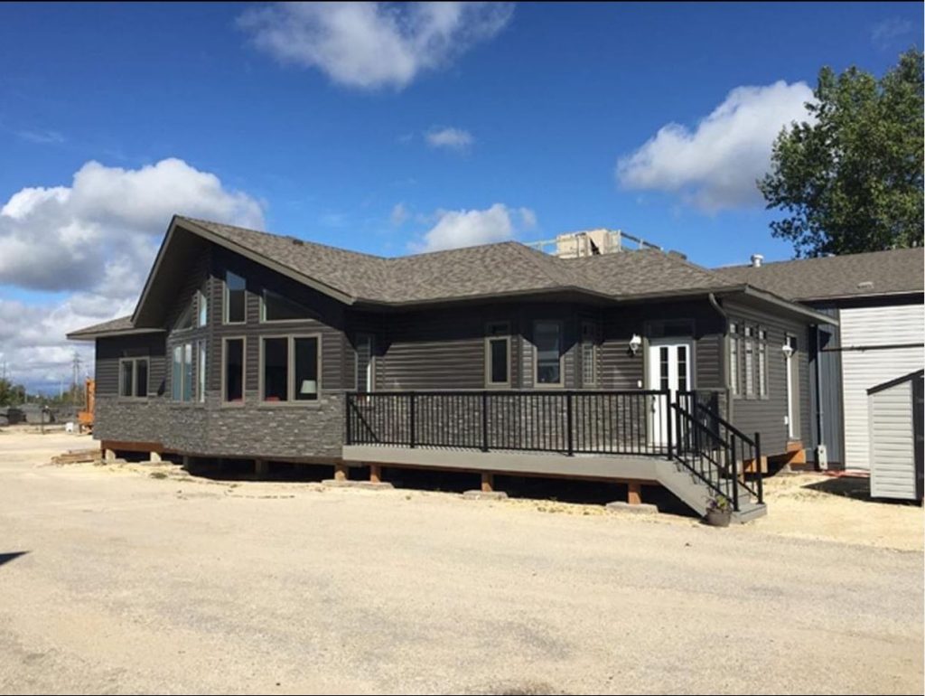 Finished Brylee Developments home with covered deck and attached garage